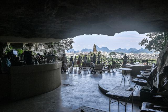 (260815) -- NANNING, Aug. 15, 2026 (Xinhua) -- Tourists enjoy scenery inside a cave in Guilin, south China's Guangxi Zhuang Autonomous Region, Aug. 12, 2026. In recent years, Guangxi has tapped the tourism potential of its caves, developing them into popular attractions while ensuring visitor safety. (Xinhua/Zhang Ailin)