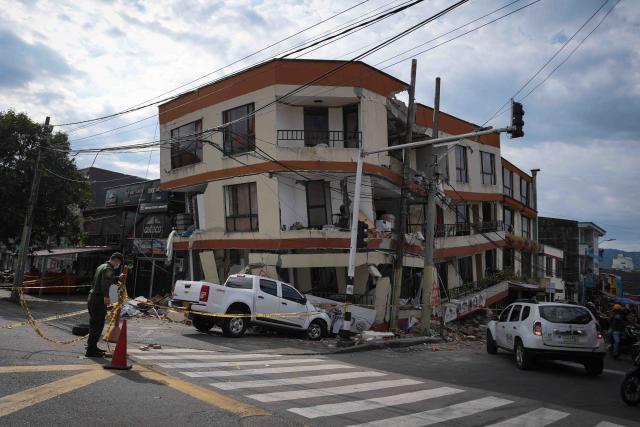 (260815) -- PEREIRA, Aug. 15, 2026 (Xinhua) -- This photo taken on Aug. 14, 2026 shows vehicles and buildings damaged in an earthquake in Pereira, Colombia.
  A 7.4-magnitude earthquake jolted western Colombia on Monday. (Photo by Andres Moreno/Xinhua)