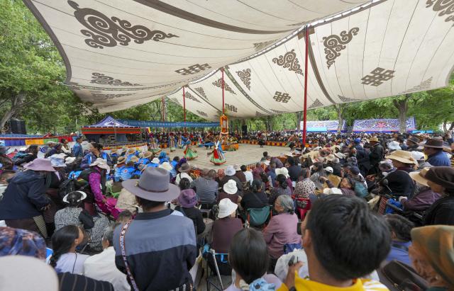 (260815) -- LHASA, Aug. 15, 2026 (Xinhua) -- People watch a Tibetan opera during the Shoton Festival in Lhasa, southwest China's Xizang Autonomous Region, Aug. 15, 2026. Tibetan opera blends talking, singing, acting, dancing and literature, which is a must-see performance for visitors during the Shoton Festival. (Xinhua/Jigme Dorje)
