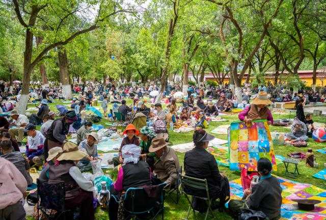 (260815) -- LHASA, Aug. 15, 2026 (Xinhua) -- People enjoy leisure time at Norbulingka in Lhasa, southwest China's Xizang Autonomous Region, on Aug. 15, 2026. "Lingka" means "garden" in the Tibetan language. In Xizang, people follow a tradition of spending the Lingka time, when they camp out and have picnics in parks or suburbs. During the traditional Shoton Festival holiday, which runs from Aug. 14 to 16 this year, people enjoy Lingka time with family and friends. (Xinhua/Tenzin Nyida)