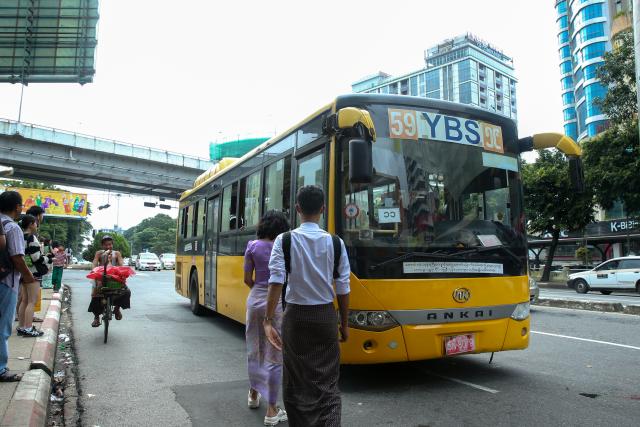 (260815) -- YANGON, Aug. 15, 2026 (Xinhua) -- People prepare to get on a Yangon Bus Service (YBS) bus in Yangon, Myanmar, Aug. 15, 2026. Public bus fares on the Yangon Bus Service (YBS) routes, the main public bus network in Yangon, will increase from Sept. 1 to address rising costs of vehicle spare parts and maintenance, the state-owned daily The Global New Light of Myanmar reported Saturday. (Xinhua/Myo Kyaw Soe)