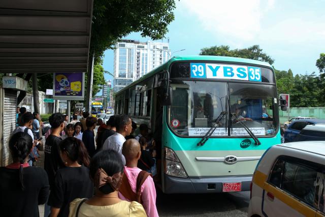 (260815) -- YANGON, Aug. 15, 2026 (Xinhua) -- People get on a Yangon Bus Service (YBS) bus in Yangon, Myanmar, Aug. 15, 2026. Public bus fares on the Yangon Bus Service (YBS) routes, the main public bus network in Yangon, will increase from Sept. 1 to address rising costs of vehicle spare parts and maintenance, the state-owned daily The Global New Light of Myanmar reported Saturday. (Xinhua/Myo Kyaw Soe)