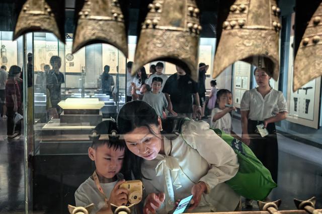 (260815) -- WUHAN, Aug. 15, 2026 (Xinhua) -- People visit the Jingzhou Museum in Jingzhou City, central China's Hubei Province, Aug. 15, 2026. Museums in Hubei Province have seen a surging number of children and teenagers on study tours during the summer vacation. With guided tours, hands-on experiences, and intangible cultural heritage classes, these museums are offering more than just exhibitions to enrich the summer life of children and students. (Xinhua/Shen Hongbing)