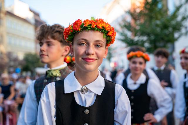 (260815) -- PRAGUE, Aug. 15, 2026 (Xinhua) -- People take part in a parade during the Summer Folklore Festival in Prague, the Czech Republic, Aug. 15, 2026. The Summer Folklore Festival was held in Prague on Saturday, bringing together international folklore ensembles presenting their traditional dances, music and costumes. (Photo by Dana Kesnerova/Xinhua)