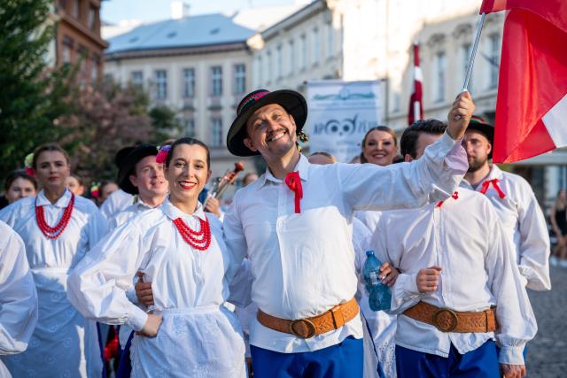 (260815) -- PRAGUE, Aug. 15, 2026 (Xinhua) -- People take part in a parade during the Summer Folklore Festival in Prague, the Czech Republic, Aug. 15, 2026. The Summer Folklore Festival was held in Prague on Saturday, bringing together international folklore ensembles presenting their traditional dances, music and costumes. (Photo by Dana Kesnerova/Xinhua)