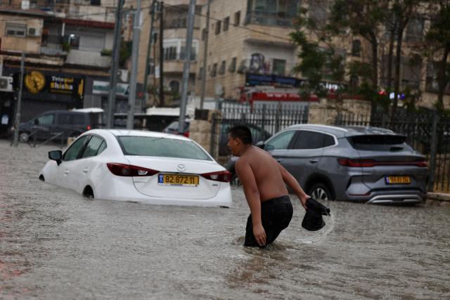 (260815) -- JERUSALEM, Aug. 15, 2026 (Xinhua) -- Photo taken on Aug. 15, 2026 shows a flooded road section in Jerusalem. Rare heavy downpours trigger mountain flash floods and urban waterlogging across Jerusalem on Saturday. The region is currently in midsummer, a period typically marked by extreme drought and almost zero precipitation. (Photo by Jamal Awad/Xinhua)