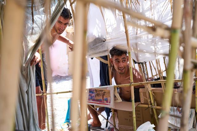 (260815) -- CEUTA, Aug. 15, 2026 (Xinhua) -- Irregular migrants rest in a makeshift shelter in Ceuta, Spain, Aug. 15, 2026. More than 72,000 migrants crossed irregularly into Ceuta from neighboring Morocco on July 30 and 31, according to the Spanish government. Most returned to Morocco later, while thousands remain in the enclave.Security was also tightened along the border ahead of Saturday after calls for another mass crossing circulated on social media. Moroccan security forces intercepted hundreds of migrants attempting to reach the border area, while Ceuta reported no influx on a scale comparable to that seen in late July. (Xinhua/Meng Dingbo)