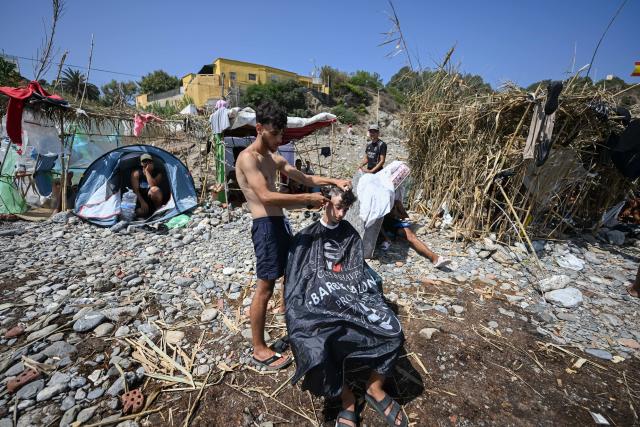 (260815) -- CEUTA, Aug. 15, 2026 (Xinhua) -- Irregular migrants are seen in Ceuta, Spain, Aug. 15, 2026. More than 72,000 migrants crossed irregularly into Ceuta from neighboring Morocco on July 30 and 31, according to the Spanish government. Most returned to Morocco later, while thousands remain in the enclave.Security was also tightened along the border ahead of Saturday after calls for another mass crossing circulated on social media. Moroccan security forces intercepted hundreds of migrants attempting to reach the border area, while Ceuta reported no influx on a scale comparable to that seen in late July. (Xinhua/Cheng Min)