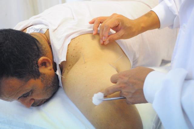 (260816) -- TUNIS, Aug. 16, 2026 (Xinhua) -- A doctor provides acupuncture treatment to a patient as a complement to Sanfutie, or Sanfu plaster, a centuries-old traditional Chinese medicine therapy, in Tunis, Tunisia, Aug. 14, 2026. The 30th Chinese medical team to Tunisia conducted Sanfutie treatments for the Tunisian people on Friday. (Photo by Adel Ezzine/Xinhua)