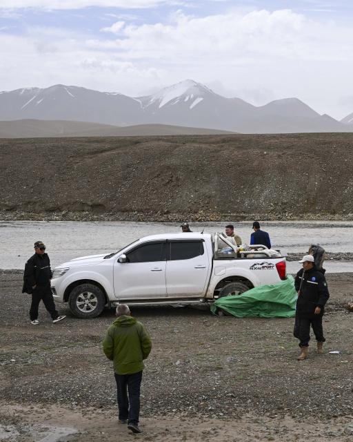 (260816) -- RUOQIANG, Aug. 16, 2026 (Xinhua) -- Rangers check an abandoned car left by illegal intruders in the Altun Mountain National Nature Reserve in northwest China's Xinjiang Uygur Autonomous Region, on Aug. 8, 2026. Averaging 4,500 meters in elevation, the Altun Mountain National Nature Reserve, a 45,000-square-kilometer haven situated in the southeastern corner of Xinjiang, is subject to harsh environmental conditions. 
   In early August, a patrol team comprising nature reserve staff, local township officials and police officers ventured into this remote plateau wilderness for a monthly routine patrol.  
   Bumping along a dry river valley winding through the mountains, the team members checked for suspicious signs, observed wildlife, and maintained management station facilities. They conducted routine inspections within the reserve supported by advanced technological equipment, including high-altitude surveillance cameras, infrared cameras and drones. Their main mission was to curb illegal activities to ensure protection of one of China's most remote and ecologically vital sanctuaries. 
  At nearly 4,800 meters above sea level, almost every member of the team suffered from altitude sickness like headaches and insomnia, but their firm conviction to protect this reserve gave them strength to overcome challenges and carry on with their work. 
  Established in 1983, the reserve is managed by a team of about 70 people. Over the past 40 years, generation after generation of patrollers have devoted themselves to protecting this land with stark contrasts and rich biodiversity. (Xinhua/Hu Huhu)