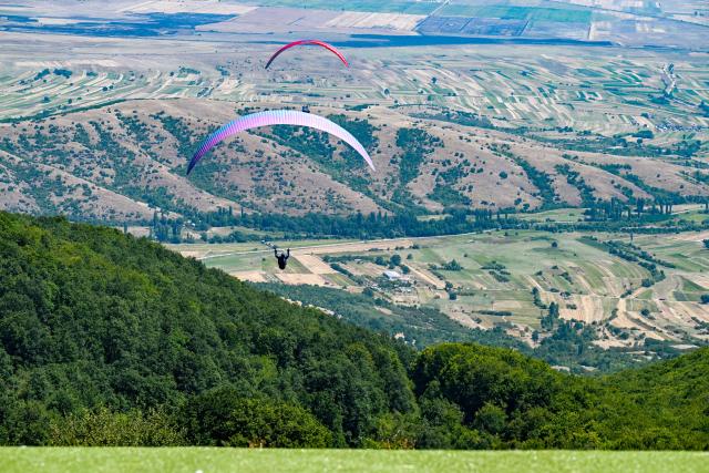 (260816) -- KRUSHEVO, Aug. 16, 2026 (Xinhua) -- Participants compete during the 18th World Air Sports Federation (FAI) European Paragliding Championships in Krushevo, North Macedonia, Aug.16, 2026. The event is taking place from Aug. 8 to 19, bringing together 130 of Europe's top pilots. (Photo by Tomislav Georgiev/Xinhua)