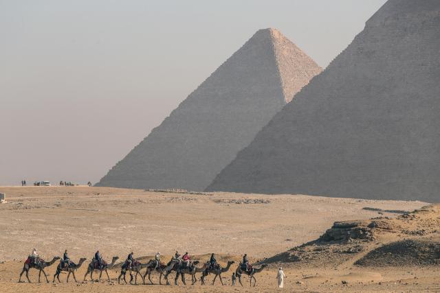 (260816) -- GIZA, Aug. 16, 2026 (Xinhua) -- Tourists ride camels at the Pyramids scenic spot in Giza, Egypt, Aug. 16, 2026. (Xinhua/Ahmed Gomaa)