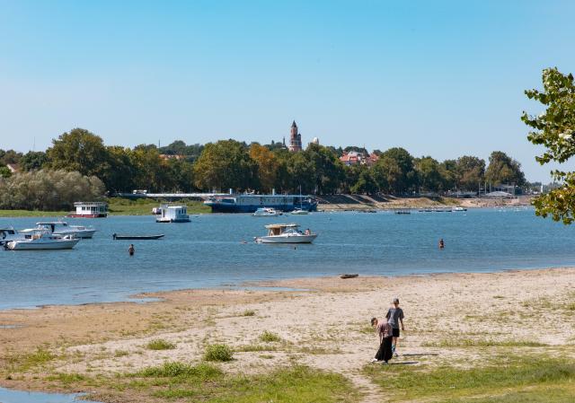 (260816) -- BELGRADE, Aug. 16, 2026 (Xinhua) -- People take a stroll on the bank of the Danube River in Belgrade, Serbia, on Aug. 16, 2026. Riverbed was exposed as the water level of the Danube River approached record-low by severe drought. (Photo by Wang Wei/Xinhua)