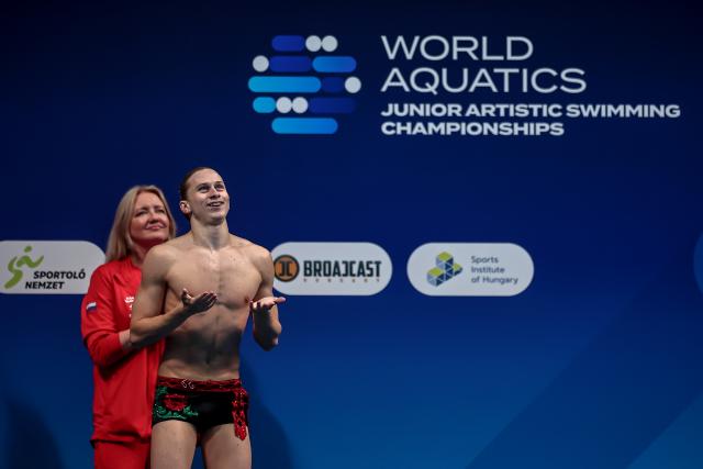 (260817) -- BUDAPEST, Aug. 17, 2026 (Xinhua) -- Zakhar Trofimov (R) of Russia reacts after the Men's Solo Free Final of the World Aquatics Junior Artistic Swimming Championships in Budapest, Hungary, on Aug. 16, 2026. (Photo by David Balogh/Xinhua)