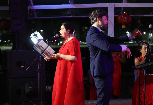 (260817) -- RIO DE JANEIRO, Aug. 17, 2026 (Xinhua) -- Brazilian soprano Marilia Vargas (L) sings a Chinese song during a concert marking the 52nd anniversary of China-Brazil diplomatic relations at the Forte de Copacabana in Rio de Janeiro, Brazil, Aug. 16, 2026. The concert was held here on Sunday. (Xinhua/Jin Haoyuan)
