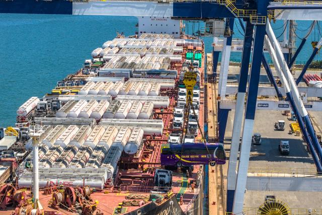 (260817) -- YANTAI, Aug. 17, 2026 (Xinhua) -- A drone photo taken on Aug. 16, 2026 shows China-produced buses bound for Ghana being loaded onto a ship at Yantai Port in east China's Shandong. Yantai Port's general cargo shipment volume to Africa has exceeded 6 million tonnes since the beginning of this year, a year-on-year increase of 66.1 percent. (Photo by Zhang Chao/Xinhua)