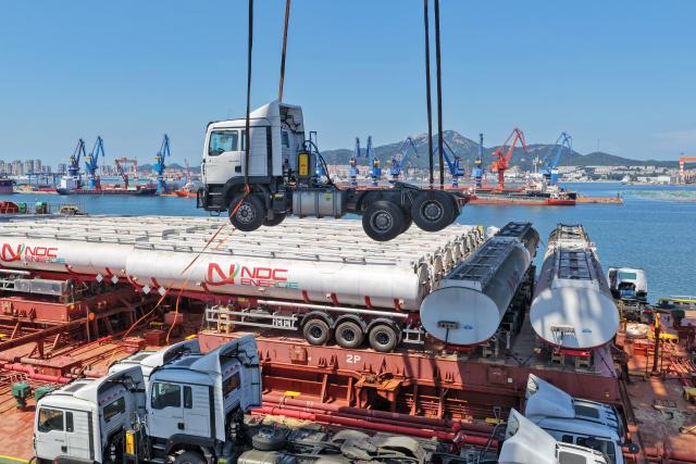 (260817) -- YANTAI, Aug. 17, 2026 (Xinhua) -- A drone photo taken on Aug. 16, 2026 shows China-produced trucks bound for Ghana being loaded onto a ship at Yantai Port in east China's Shandong. Yantai Port's general cargo shipment volume to Africa has exceeded 6 million tonnes since the beginning of this year, a year-on-year increase of 66.1 percent. (Photo by Tang Ke/Xinhua)