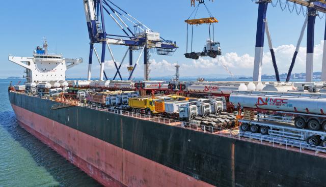 (260817) -- YANTAI, Aug. 17, 2026 (Xinhua) -- A drone photo taken on Aug. 16, 2026 shows China-produced trucks bound for Ghana being loaded onto a vessel at Yantai Port in east China's Shandong. Yantai Port's general cargo shipment volume to Africa has exceeded 6 million tonnes since the beginning of this year, a year-on-year increase of 66.1 percent. (Photo by Tang Ke/Xinhua)