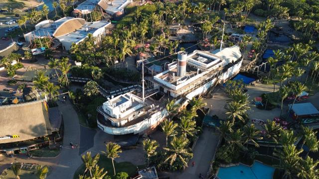 (260818) -- BEIJING, Aug. 18, 2026 (Xinhua) -- An aerial drone photo taken on Aug. 16, 2026 shows an exterior view of the aquarium at uShaka Marine World in Durban, South Africa. Located in Durban, uShaka Marine World is a marine theme park featuring a shipwreck-themed aquarium, marine life exhibits and water attractions. (Xinhua/Chen Wei)