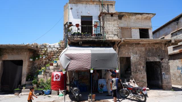 (260818) -- QALAAT AL-MADIQ, Aug. 18, 2026 (Xinhua) -- A small shop is pictured among old and damaged buildings inside Qalaat al-Madiq in Hama province, central Syria, June 24, 2026.
  TO GO WITH "Letter from Mideast: In a Syrian castle, a laurel still stands" (Photo by Monsef Memari/Xinhua)