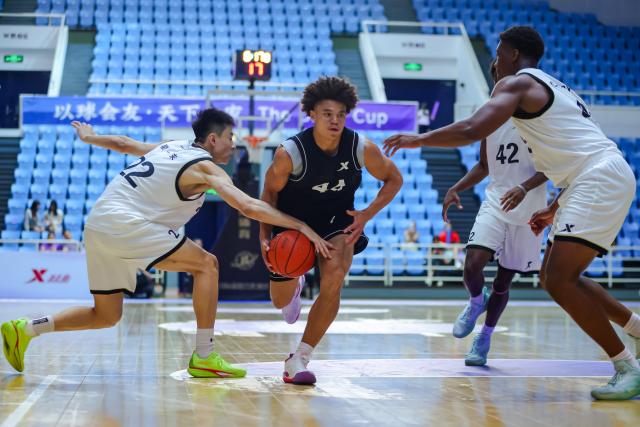 (260818) -- BEIJING, Aug. 18, 2026 (Xinhua) -- Chinese and American college students compete during a basketball game at Tsinghua University's sports complex in Beijing, capital of China, Aug. 16, 2026.
  TO GO WITH "China Focus: China-U.S. basketball exchange brings young players together on and off court" (Xinhua)