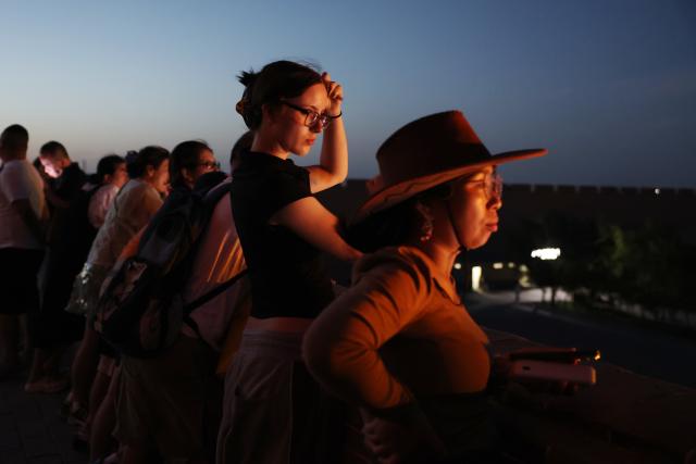 (260818) -- BEIJING, Aug. 18, 2026 (Xinhua) -- Tourists enjoy a performance at the Jiayu Pass in the city of Jiayuguan, northwest China's Gansu Province, Aug. 5, 2026. Jiayuguan, the westernmost point of China's Ming Dynasty Great Wall, and the ancient city of Petra in Jordan are both landmarks boasting rich cultural heritage.
  In 2017, they established a twinhood relationship, built on the fact that both are UNESCO-listed World Heritage sites, distinguished by their unique and creative architecture in harmony with the natural environment.
  In 2025, the Chinese city of Jiayuguan and the Jordanian city of Petra signed an agreement on cooperation in culture and tourism at the archaeological site of Petra, seeking to strengthen the friendly ties between the two historical sites. (Xinhua/Chen Bin)