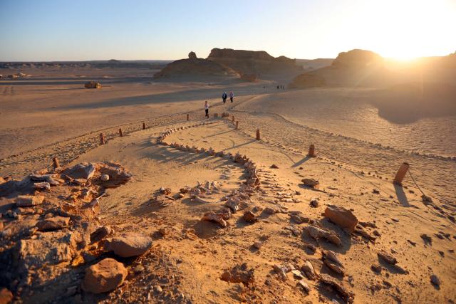 (260818) -- FAYOUM, Aug. 18, 2026 (Xinhua) -- Tourists visit whale fossil remains at Wadi Al-Hitan, or the Whale Valley, in Fayoum, western Egypt, on Aug. 18, 2026. Wadi Al-Hitan, or the Whale Valley, located in the western desert of Egypt, contains invaluable fossil remains of the earliest, and now extinct, suborder of whales, Archaeoceti. It was listed as a World Heritage Site by UNESCO in 2005. (Xinhua/Ahmed Gomaa)