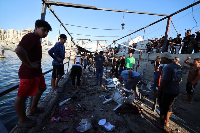(260818) -- GAZA, Aug. 18, 2026 (Xinhua) -- Palestinians inspect the site after an Israeli airstrike hit a cafe in the seaport area, west of Gaza City, on Aug. 18, 2026. At least six Palestinians, including a child, were killed and 14 others injured on Tuesday in an Israeli airstrike that hit a cafe in the seaport area west of Gaza City. (Photo by Rizek Abdeljawad/Xinhua)