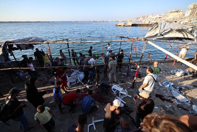 (260818) -- GAZA, Aug. 18, 2026 (Xinhua) -- Palestinians inspect the site after an Israeli airstrike hit a cafe in the seaport area, west of Gaza City, on Aug. 18, 2026. At least six Palestinians, including a child, were killed and 14 others injured on Tuesday in an Israeli airstrike that hit a cafe in the seaport area west of Gaza City. (Photo by Rizek Abdeljawad/Xinhua)
