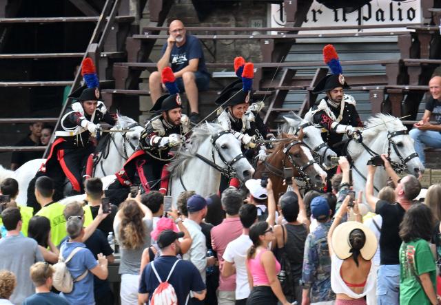 (260819) -- SIENA, Aug. 19, 2026 (Xinhua) -- Italian Carabinieri, known as the gendarmerie of Italy, perform before the Palio in Siena, Italy, Aug. 18, 2026. Palio in Siena, or "Palio di Siena" in Italian, is a historical horse race held twice a year in Siena since 1656. (Photo by Alberto Lingria/Xinhua)