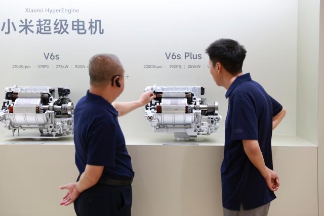 (260819) -- BEIJING, Aug. 19, 2026 (Xinhua) -- People learn about Xiaomi HyperEngine at an exhibition hall of the Xiaomi auto factory in Beijing, capital of China, July 2, 2026. The Beijing Economic-Technological Development Area, also known as Beijing E-Town, has managed to cultivate and strengthen a modern system of emerging and forward-looking industries. (Photo by Ma Zihan/Xinhua)