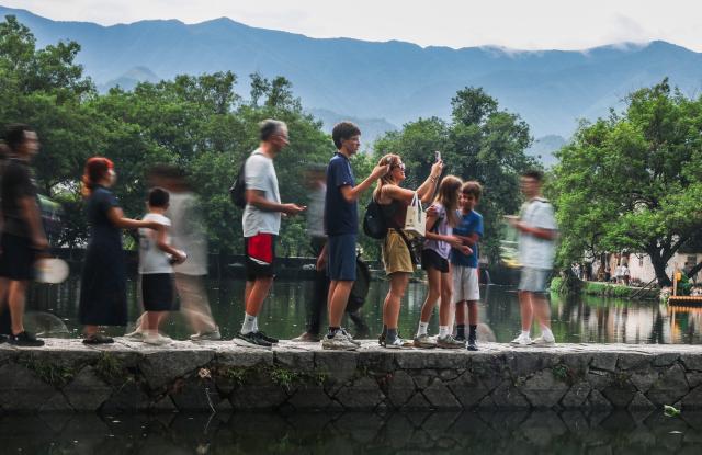 (260819) -- HUANGSHAN, Aug. 19, 2026 (Xinhua) -- People visit Hongcun Village, Yixian County of Huangshan City, east China's Anhui Province, Aug. 18, 2026. (Xinhua/Chang Nengjia)