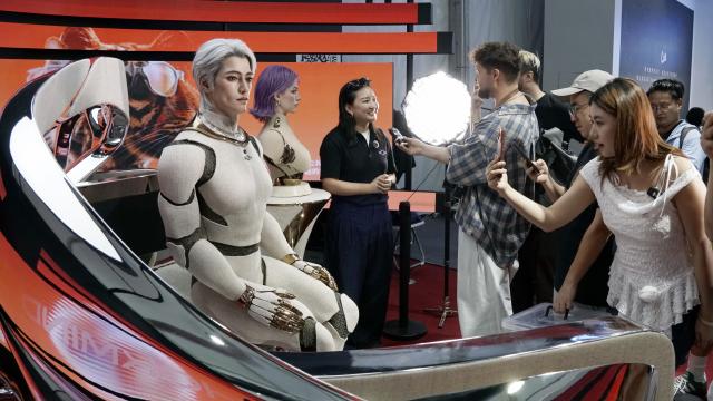 (260819) -- BEIJING, Aug. 19, 2026 (Xinhua) -- A visitor takes photos of a humanoid robot during the 2026 World Robot Conference in Beijing, capital of China, Aug. 19, 2026. Themed "Human-Robot Symbiosis, Production-Demand Convergence," the 2026 edition of the conference kicked off here on Wednesday. (Xinhua/Li Xin)