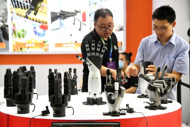 (260819) -- BEIJING, Aug. 19, 2026 (Xinhua) -- Dexterous robotic hands are displayed during the 2026 World Robot Conference in Beijing, capital of China, Aug. 19, 2026. Themed "Human-Robot Symbiosis, Production-Demand Convergence," the 2026 edition of the conference kicked off here on Wednesday. (Xinhua/Ren Chao)