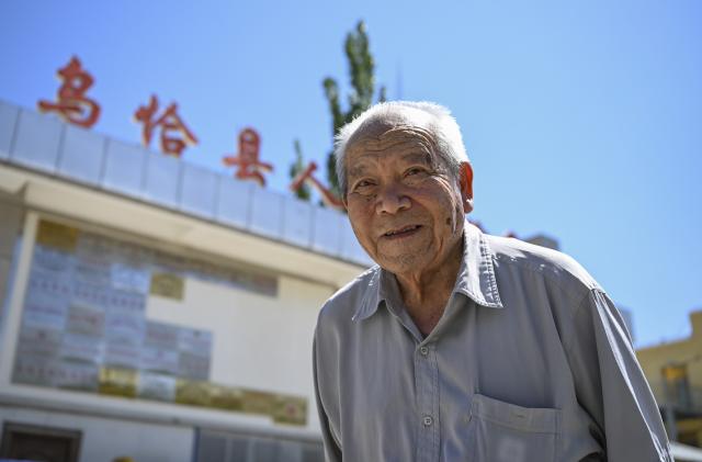 (260819) -- WUQIA, Aug. 19, 2026 (Xinhua) -- Wu Dengyun is pictured at the people's hospital of Wuqia County in Kirgiz Autonomous Prefecture of Kizilsu, northwest China's Xinjiang Uygur Autonomous Region, July 30, 2026. Wu Dengyun, then 23 years old, started his career in Wuqia County in 1963, after graduating from a medical school in Yangzhou of east China's Jiangsu Province.
   High in altitude and sparsely populated, Wuqia had long suffered from the shortage of medical resources. Young as he was, Wu rode a horse with a medicine kit on his back, traversing mountains and valleys to deliver medical care to every village and pasture across the county.
   In the winter of 1971, Wu saved a two-year-old child suffering from severe burns. With no available skin for grafting at his hospital and no time to transfer the patient to a hospital of better conditions, he administered local anesthesia to himself, took off 13 stamp-sized pieces of skin from his own legs, and grafted them onto the patient.
   This heroic doctor also donated blood more than 30 times, transfusing over 7,000 millilitres of his blood into the vessels of his patients.
   Wu takes Wuqia as his second hometown. On several occasions, he declined job offers from his hometown Yangzhou. Even after his retirement, he clocks in at the hospital every day to undertake routine duties including clinic consultations and ward rounds. He still serves as the honorary head of the hospital.
   He has received many awards and honors over the decades, yet he rarely mentions them. When someone asked if he regretted his life, Wu said: "If there were reincarnation, I would still choose to be a medical worker, and come to Wuqia again to combat diseases for people of all ethnic groups." (Xinhua/Hu Huhu)