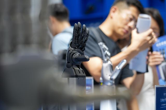 (260819) -- BEIJING, Aug. 19, 2026 (Xinhua) -- Dexterous robotic hands are displayed during the 2026 World Robot Conference in Beijing, capital of China, Aug. 19, 2026. Themed "Human-Robot Symbiosis, Production-Demand Convergence," the 2026 edition of the conference kicked off here on Wednesday. (Xinhua/Xie Han)