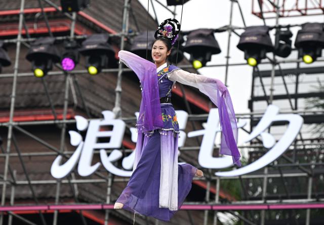 (260819) -- BAOTING, Aug. 19, 2026 (Xinhua) -- A dancer performs at the opening ceremony of a water festival held in Baoting Li and Miao Autonomous County, south China's Hainan Province, Aug. 19, 2026.
  A water festival is held here on Wednesday, on the occasion of the Qixi Festival, the Chinese version of the Valentine's Day. (Xinhua/Pu Xiaoxu)