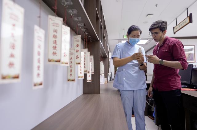 (260819) -- YINCHUAN, Aug. 19, 2026 (Xinhua) -- Mohammad Abdi (R) learns about TCM herbal drinks from a doctor at Ningxia Chinese Medicine Research Center in Yinchuan, northwest China's Ningxia Hui Autonomous Region, on Aug. 15, 2026. Mohammad Abdi, a 26-year-old Iranian student, came to China in 2023 to study clinical medicine at Ningxia Medical University.
   He was introduced to traditional Chinese medicine (TCM) at an early age. After seeing his uncle receive cupping therapy in Iran, he became curious about this traditional medical practice. Later, as a medical student in China, he had the opportunity to take professional TCM courses. On weekends, Abdi visits Ningxia Chinese Medicine Research Center to experience various TCM therapies.
   "I was a gym rat, so I initially thought TCM practices were too simple to be effective," he said. However, as he learned more about TCM, he was impressed by its depth and effectiveness. He recommended Baduanjin, a traditional Chinese breathing and stretching exercise, to his fellow international students, while he especially enjoys tuina massage combined with cupping therapy, which helps relieve the stress of his studies and clinical internship.
   For Abdi, TCM is more than a way to treat diseases; it is also a health philosophy that can be integrated into daily life. He believes ordinary people can benefit from TCM-based wellness practices, while professional doctors can use TCM techniques to treat patients.
   TCM is now expanding its global presence and joining the worldwide conversation on health and lifestyle. Inspired by growing interest in Chinese lifestyles overseas, Abdi hopes to continue exploring TCM and become a skilled doctor, helping more people in his hometown benefit from traditional Chinese medicine. (Xinhua/Yang Zhisen)