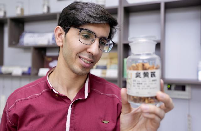 (260819) -- YINCHUAN, Aug. 19, 2026 (Xinhua) -- Mohammad Abdi observes a variety of traditional Chinese medicine at Ningxia Chinese Medicine Research Center in Yinchuan, northwest China's Ningxia Hui Autonomous Region, on Aug. 15, 2026. Mohammad Abdi, a 26-year-old Iranian student, came to China in 2023 to study clinical medicine at Ningxia Medical University.
   He was introduced to traditional Chinese medicine (TCM) at an early age. After seeing his uncle receive cupping therapy in Iran, he became curious about this traditional medical practice. Later, as a medical student in China, he had the opportunity to take professional TCM courses. On weekends, Abdi visits Ningxia Chinese Medicine Research Center to experience various TCM therapies.
   "I was a gym rat, so I initially thought TCM practices were too simple to be effective," he said. However, as he learned more about TCM, he was impressed by its depth and effectiveness. He recommended Baduanjin, a traditional Chinese breathing and stretching exercise, to his fellow international students, while he especially enjoys tuina massage combined with cupping therapy, which helps relieve the stress of his studies and clinical internship.
   For Abdi, TCM is more than a way to treat diseases; it is also a health philosophy that can be integrated into daily life. He believes ordinary people can benefit from TCM-based wellness practices, while professional doctors can use TCM techniques to treat patients.
   TCM is now expanding its global presence and joining the worldwide conversation on health and lifestyle. Inspired by growing interest in Chinese lifestyles overseas, Abdi hopes to continue exploring TCM and become a skilled doctor, helping more people in his hometown benefit from traditional Chinese medicine. (Xinhua/Yang Zhisen)