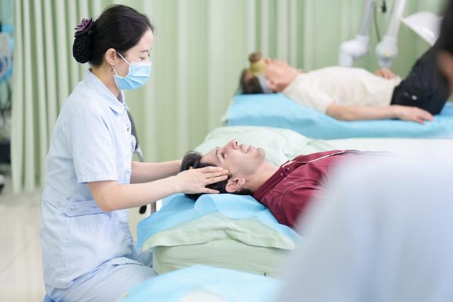 (260819) -- YINCHUAN, Aug. 19, 2026 (Xinhua) -- Mohammad Abdi experiences a traditional Chinese medical treatment therapy on head at Ningxia Chinese Medicine Research Center in Yinchuan, northwest China's Ningxia Hui Autonomous Region, on Aug. 15, 2026. Mohammad Abdi, a 26-year-old Iranian student, came to China in 2023 to study clinical medicine at Ningxia Medical University.
   He was introduced to traditional Chinese medicine (TCM) at an early age. After seeing his uncle receive cupping therapy in Iran, he became curious about this traditional medical practice. Later, as a medical student in China, he had the opportunity to take professional TCM courses. On weekends, Abdi visits Ningxia Chinese Medicine Research Center to experience various TCM therapies.
   "I was a gym rat, so I initially thought TCM practices were too simple to be effective," he said. However, as he learned more about TCM, he was impressed by its depth and effectiveness. He recommended Baduanjin, a traditional Chinese breathing and stretching exercise, to his fellow international students, while he especially enjoys tuina massage combined with cupping therapy, which helps relieve the stress of his studies and clinical internship.
   For Abdi, TCM is more than a way to treat diseases; it is also a health philosophy that can be integrated into daily life. He believes ordinary people can benefit from TCM-based wellness practices, while professional doctors can use TCM techniques to treat patients.
   TCM is now expanding its global presence and joining the worldwide conversation on health and lifestyle. Inspired by growing interest in Chinese lifestyles overseas, Abdi hopes to continue exploring TCM and become a skilled doctor, helping more people in his hometown benefit from traditional Chinese medicine. (Xinhua/Yang Zhisen)