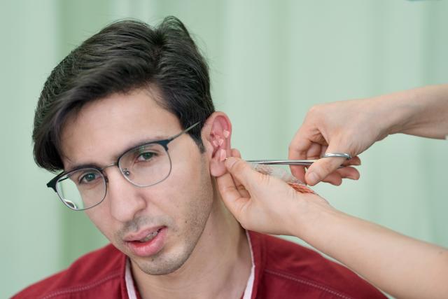 (260819) -- YINCHUAN, Aug. 19, 2026 (Xinhua) -- Mohammad Abdi experiences a traditional Chinese medical treatment on ears at Ningxia Chinese Medicine Research Center in Yinchuan, northwest China's Ningxia Hui Autonomous Region, on Aug. 15, 2026. Mohammad Abdi, a 26-year-old Iranian student, came to China in 2023 to study clinical medicine at Ningxia Medical University.
   He was introduced to traditional Chinese medicine (TCM) at an early age. After seeing his uncle receive cupping therapy in Iran, he became curious about this traditional medical practice. Later, as a medical student in China, he had the opportunity to take professional TCM courses. On weekends, Abdi visits Ningxia Chinese Medicine Research Center to experience various TCM therapies.
   "I was a gym rat, so I initially thought TCM practices were too simple to be effective," he said. However, as he learned more about TCM, he was impressed by its depth and effectiveness. He recommended Baduanjin, a traditional Chinese breathing and stretching exercise, to his fellow international students, while he especially enjoys tuina massage combined with cupping therapy, which helps relieve the stress of his studies and clinical internship.
   For Abdi, TCM is more than a way to treat diseases; it is also a health philosophy that can be integrated into daily life. He believes ordinary people can benefit from TCM-based wellness practices, while professional doctors can use TCM techniques to treat patients.
   TCM is now expanding its global presence and joining the worldwide conversation on health and lifestyle. Inspired by growing interest in Chinese lifestyles overseas, Abdi hopes to continue exploring TCM and become a skilled doctor, helping more people in his hometown benefit from traditional Chinese medicine. (Xinhua/Yang Zhisen)