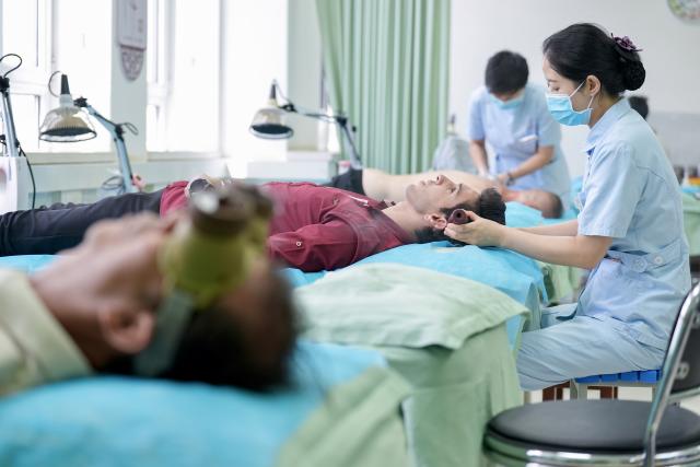 (260819) -- YINCHUAN, Aug. 19, 2026 (Xinhua) -- Mohammad Abdi experiences a traditional Chinese medical treatment therapy on head at Ningxia Chinese Medicine Research Center in Yinchuan, northwest China's Ningxia Hui Autonomous Region, on Aug. 15, 2026. Mohammad Abdi, a 26-year-old Iranian student, came to China in 2023 to study clinical medicine at Ningxia Medical University.
   He was introduced to traditional Chinese medicine (TCM) at an early age. After seeing his uncle receive cupping therapy in Iran, he became curious about this traditional medical practice. Later, as a medical student in China, he had the opportunity to take professional TCM courses. On weekends, Abdi visits Ningxia Chinese Medicine Research Center to experience various TCM therapies.
   "I was a gym rat, so I initially thought TCM practices were too simple to be effective," he said. However, as he learned more about TCM, he was impressed by its depth and effectiveness. He recommended Baduanjin, a traditional Chinese breathing and stretching exercise, to his fellow international students, while he especially enjoys tuina massage combined with cupping therapy, which helps relieve the stress of his studies and clinical internship.
   For Abdi, TCM is more than a way to treat diseases; it is also a health philosophy that can be integrated into daily life. He believes ordinary people can benefit from TCM-based wellness practices, while professional doctors can use TCM techniques to treat patients.
   TCM is now expanding its global presence and joining the worldwide conversation on health and lifestyle. Inspired by growing interest in Chinese lifestyles overseas, Abdi hopes to continue exploring TCM and become a skilled doctor, helping more people in his hometown benefit from traditional Chinese medicine. (Xinhua/Yang Zhisen)