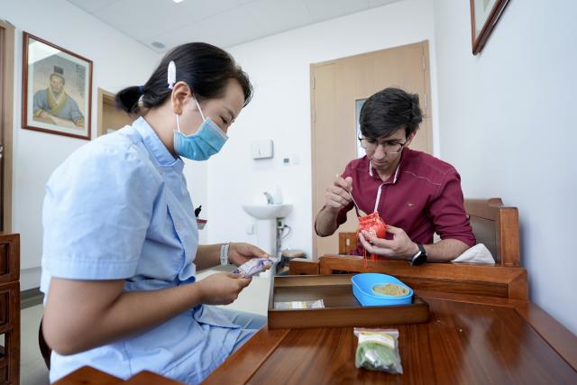 (260819) -- YINCHUAN, Aug. 19, 2026 (Xinhua) -- Mohammad Abdi (R) learns to make a sachet filled with traditional Chinese medicine materials at Ningxia Chinese Medicine Research Center in Yinchuan, northwest China's Ningxia Hui Autonomous Region, on Aug. 15, 2026. Mohammad Abdi, a 26-year-old Iranian student, came to China in 2023 to study clinical medicine at Ningxia Medical University.
   He was introduced to traditional Chinese medicine (TCM) at an early age. After seeing his uncle receive cupping therapy in Iran, he became curious about this traditional medical practice. Later, as a medical student in China, he had the opportunity to take professional TCM courses. On weekends, Abdi visits Ningxia Chinese Medicine Research Center to experience various TCM therapies.
   "I was a gym rat, so I initially thought TCM practices were too simple to be effective," he said. However, as he learned more about TCM, he was impressed by its depth and effectiveness. He recommended Baduanjin, a traditional Chinese breathing and stretching exercise, to his fellow international students, while he especially enjoys tuina massage combined with cupping therapy, which helps relieve the stress of his studies and clinical internship.
   For Abdi, TCM is more than a way to treat diseases; it is also a health philosophy that can be integrated into daily life. He believes ordinary people can benefit from TCM-based wellness practices, while professional doctors can use TCM techniques to treat patients.
   TCM is now expanding its global presence and joining the worldwide conversation on health and lifestyle. Inspired by growing interest in Chinese lifestyles overseas, Abdi hopes to continue exploring TCM and become a skilled doctor, helping more people in his hometown benefit from traditional Chinese medicine. (Xinhua/Yang Zhisen)