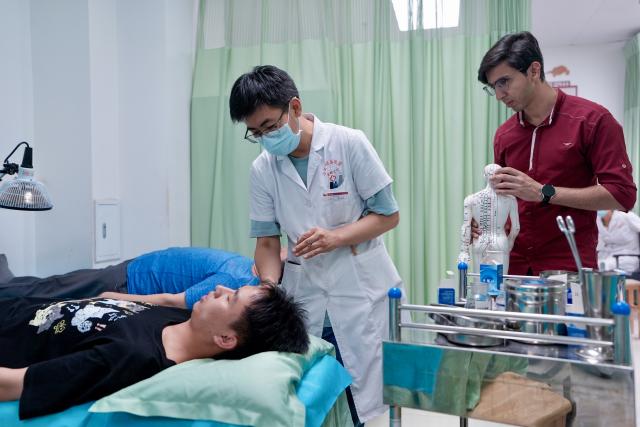 (260819) -- YINCHUAN, Aug. 19, 2026 (Xinhua) -- Mohammad Abdi (R) watches a doctor conducting acupuncture therapy to a patient at Ningxia Chinese Medicine Research Center in Yinchuan, northwest China's Ningxia Hui Autonomous Region, on Aug. 15, 2026. Mohammad Abdi, a 26-year-old Iranian student, came to China in 2023 to study clinical medicine at Ningxia Medical University.
   He was introduced to traditional Chinese medicine (TCM) at an early age. After seeing his uncle receive cupping therapy in Iran, he became curious about this traditional medical practice. Later, as a medical student in China, he had the opportunity to take professional TCM courses. On weekends, Abdi visits Ningxia Chinese Medicine Research Center to experience various TCM therapies.
   "I was a gym rat, so I initially thought TCM practices were too simple to be effective," he said. However, as he learned more about TCM, he was impressed by its depth and effectiveness. He recommended Baduanjin, a traditional Chinese breathing and stretching exercise, to his fellow international students, while he especially enjoys tuina massage combined with cupping therapy, which helps relieve the stress of his studies and clinical internship.
   For Abdi, TCM is more than a way to treat diseases; it is also a health philosophy that can be integrated into daily life. He believes ordinary people can benefit from TCM-based wellness practices, while professional doctors can use TCM techniques to treat patients.
   TCM is now expanding its global presence and joining the worldwide conversation on health and lifestyle. Inspired by growing interest in Chinese lifestyles overseas, Abdi hopes to continue exploring TCM and become a skilled doctor, helping more people in his hometown benefit from traditional Chinese medicine. (Xinhua/Yang Zhisen)