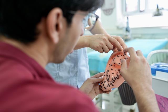 (260819) -- YINCHUAN, Aug. 19, 2026 (Xinhua) -- Mohammad Abdi learns knowledge of acupoints on human ears from a doctor at Ningxia Chinese Medicine Research Center in Yinchuan, northwest China's Ningxia Hui Autonomous Region, on Aug. 15, 2026. Mohammad Abdi, a 26-year-old Iranian student, came to China in 2023 to study clinical medicine at Ningxia Medical University.
   He was introduced to traditional Chinese medicine (TCM) at an early age. After seeing his uncle receive cupping therapy in Iran, he became curious about this traditional medical practice. Later, as a medical student in China, he had the opportunity to take professional TCM courses. On weekends, Abdi visits Ningxia Chinese Medicine Research Center to experience various TCM therapies.
   "I was a gym rat, so I initially thought TCM practices were too simple to be effective," he said. However, as he learned more about TCM, he was impressed by its depth and effectiveness. He recommended Baduanjin, a traditional Chinese breathing and stretching exercise, to his fellow international students, while he especially enjoys tuina massage combined with cupping therapy, which helps relieve the stress of his studies and clinical internship.
   For Abdi, TCM is more than a way to treat diseases; it is also a health philosophy that can be integrated into daily life. He believes ordinary people can benefit from TCM-based wellness practices, while professional doctors can use TCM techniques to treat patients.
   TCM is now expanding its global presence and joining the worldwide conversation on health and lifestyle. Inspired by growing interest in Chinese lifestyles overseas, Abdi hopes to continue exploring TCM and become a skilled doctor, helping more people in his hometown benefit from traditional Chinese medicine. (Xinhua/Yang Zhisen)