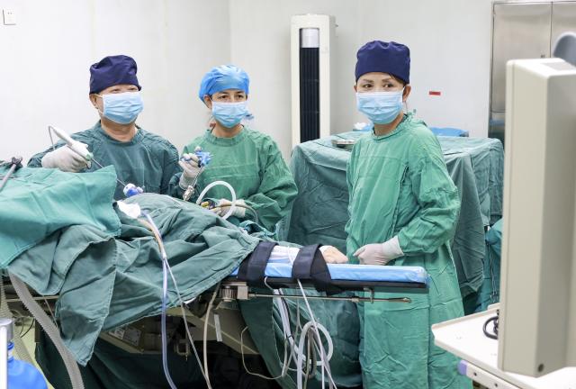 (260819) -- URUMQI, Aug. 19, 2026 (Xinhua) -- Zhuang Shihua (L) and his colleagues perform a surgery at the hospital affiliated to the Xinjiang Armed Police Corps in Urumqi, northwest China's Xinjiang Uygur Autonomous Region, Aug. 18, 2026.
  Zhuang Shihua, a veteran hepatobiliary surgeon and former president of the hospital affiliated to the Xinjiang Armed Police Corps, has been in the country's far west for over five decades.
  His team has successfully completed more than 140,000 minimally invasive hepatobiliary surgeries, and made seven breakthroughs that filled the domestic gap in the field. Apart from clinical practice, Zhuang has cultivated a large number of key personnel, and supported grassroots medical workers who have stood firm on the front lines of public health.
  Zhuang's medical expertise brought him many opportunities to make a fortune, but he turned down the offers and stayed in Xinjiang.
  Zhuang often visited patients in the pastoral areas of Tianshan Mountains. He also provided financial assistance to over 70 underprivileged students and helped more than 690 households with patients out of poverty. (Xinhua/Wang Fei)