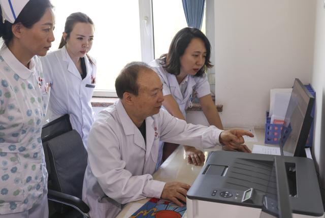(260819) -- URUMQI, Aug. 19, 2026 (Xinhua) -- Zhuang Shihua (2nd R) and his colleagues study a medical case at the hospital affiliated to the Xinjiang Armed Police Corps in Urumqi, northwest China's Xinjiang Uygur Autonomous Region, July 27, 2026.
  Zhuang Shihua, a veteran hepatobiliary surgeon and former president of the hospital affiliated to the Xinjiang Armed Police Corps, has been in the country's far west for over five decades.
  His team has successfully completed more than 140,000 minimally invasive hepatobiliary surgeries, and made seven breakthroughs that filled the domestic gap in the field. Apart from clinical practice, Zhuang has cultivated a large number of key personnel, and supported grassroots medical workers who have stood firm on the front lines of public health.
  Zhuang's medical expertise brought him many opportunities to make a fortune, but he turned down the offers and stayed in Xinjiang.
  Zhuang often visited patients in the pastoral areas of Tianshan Mountains. He also provided financial assistance to over 70 underprivileged students and helped more than 690 households with patients out of poverty. (Xinhua/Wang Fei)