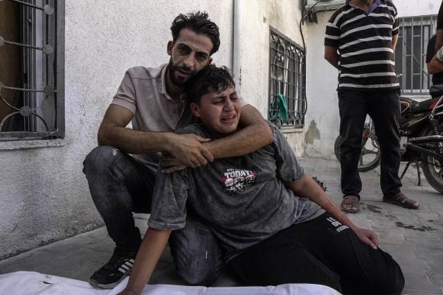 (260819) -- GAZA, Aug. 19, 2026 (Xinhua) -- Palestinians mourn over victims who were killed by an Israeli airstrike, at Al-Shifa hospital, in Gaza City, on Aug. 19, 2026. At least nine Palestinians, including a woman, were killed Wednesday in an Israeli airstrike targeting a Hamas-run municipal police headquarters in central Gaza City, according to Palestinian sources.
Sources and witnesses said the airstrike caused a large explosion and scattered shrapnel around the headquarters, which is surrounded by tents housing displaced people. (Photo by Rizek Abdeljawad/Xinhua)