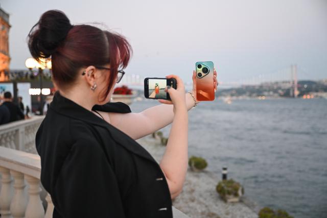 (260819) -- ISTANBUL, Aug. 19, 2026 (Xinhua) -- A guest takes a photo of a new Huawei smartphone at Huawei's new product launch event in Istanbul, Türkiye, Aug. 19, 2026. On Wednesday evening, Huawei held a product launch event in Istanbul, unveiling the Pura 90s series smartphones, tablets, smart wearables and other products for the Turkish market. (Xinhua/Liu Lei)