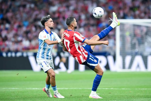 (260820) -- MADRID, Aug. 20, 2026 (Xinhua) -- Atletico de Madrid's David Hancko (R) vies with Malaga's David Larrubia during the Liga football match between Atletico de Madrid and Malaga at Metropolitano stadium in Madrid, Spain, Aug. 19, 2026. (Photo by Gustavo Valiente/Xinhua)